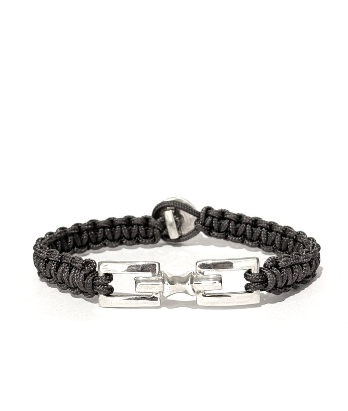 Grey hand braided bracelet with silver clasp on a white background