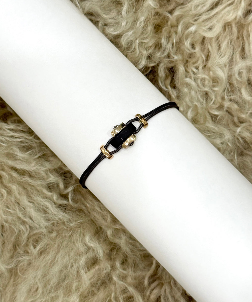 Cord bracelet with horn and yellow gold elements