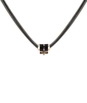 Parachute cord necklace in rose gold with a T bar, accented with gold and sustainable horn links. Unisex, refined, and waterproof—precious yet made to be worn every day.