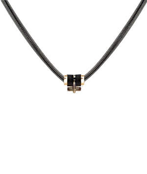 Parachute cord necklace in yellow gold with a T bar, accented with gold and sustainable horn links. Unisex, refined, and waterproof—precious yet made to be worn every day.