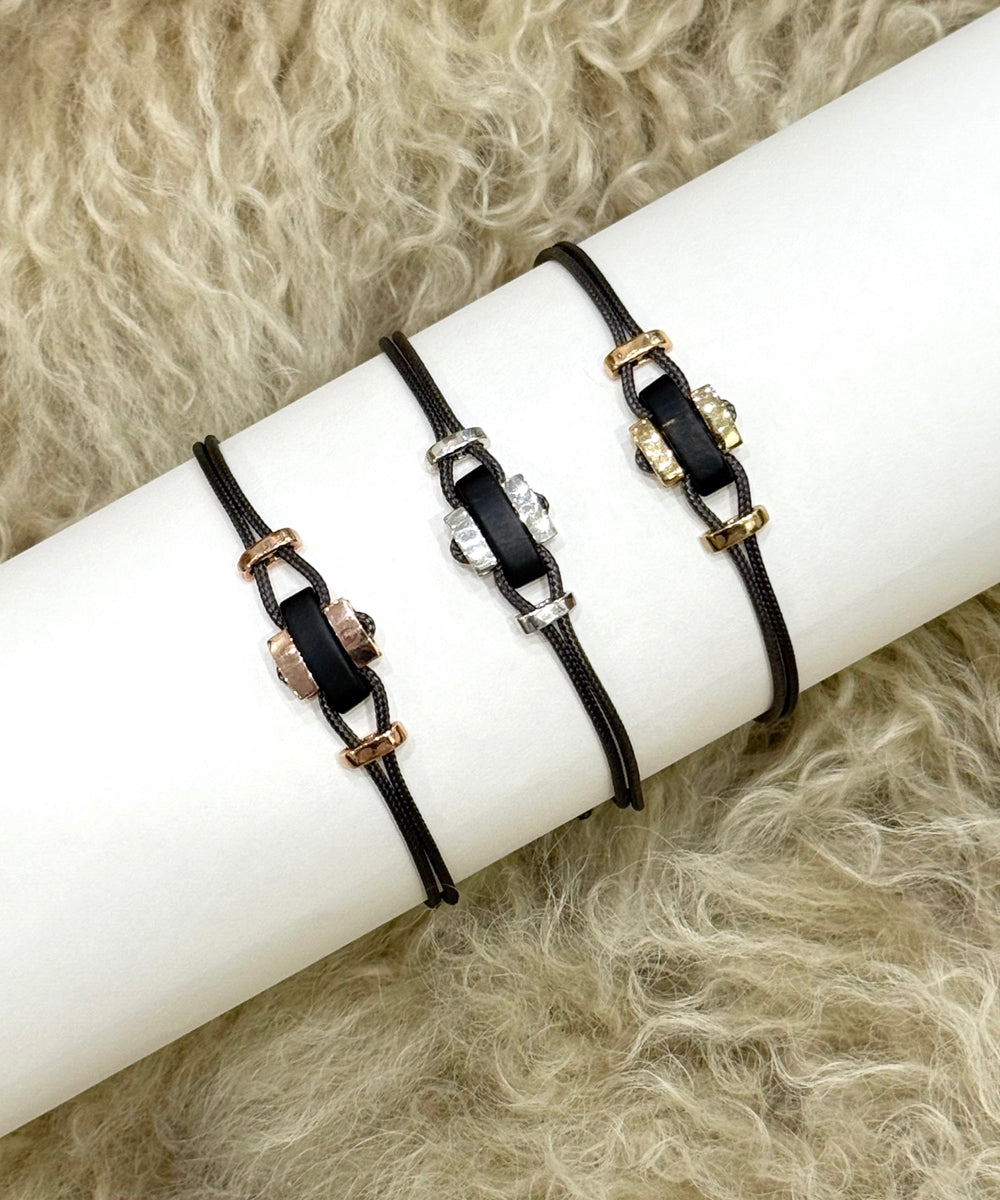 Cord bracelets with horn and three shades of gold elements