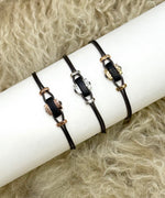 Cord bracelets with horn and three shades of gold elements