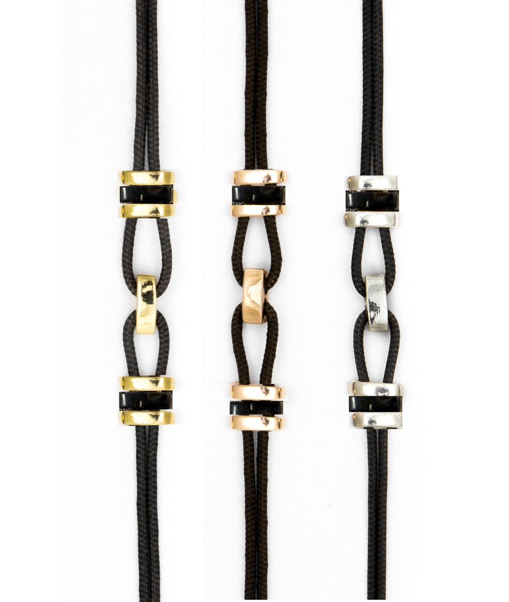 Parachute cord bracelet accented with gold and sustainable horn links. Unisex, refined, and waterproof—precious yet made to be worn every day.