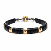 Black beaded horn bracelet with yellow gold pyramid accents on a white background