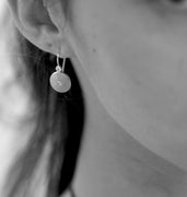 The "Circle of Life" disk earrings in 18-karat white gold with diamonds
