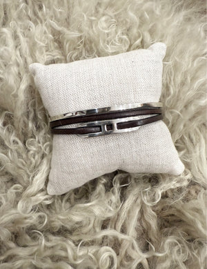 Handcrafted men's bracelet stack featuring double leather wrap with bold sterling silver detail and a minimalist silver cuff. ZADEH NY, made in NY