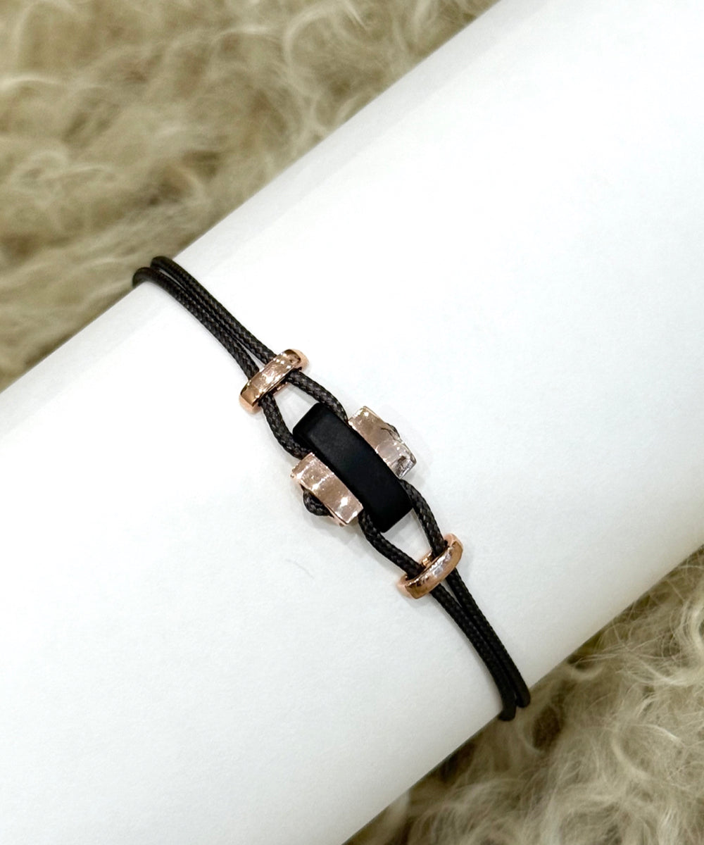 Cord bracelet with horn and rose gold elements