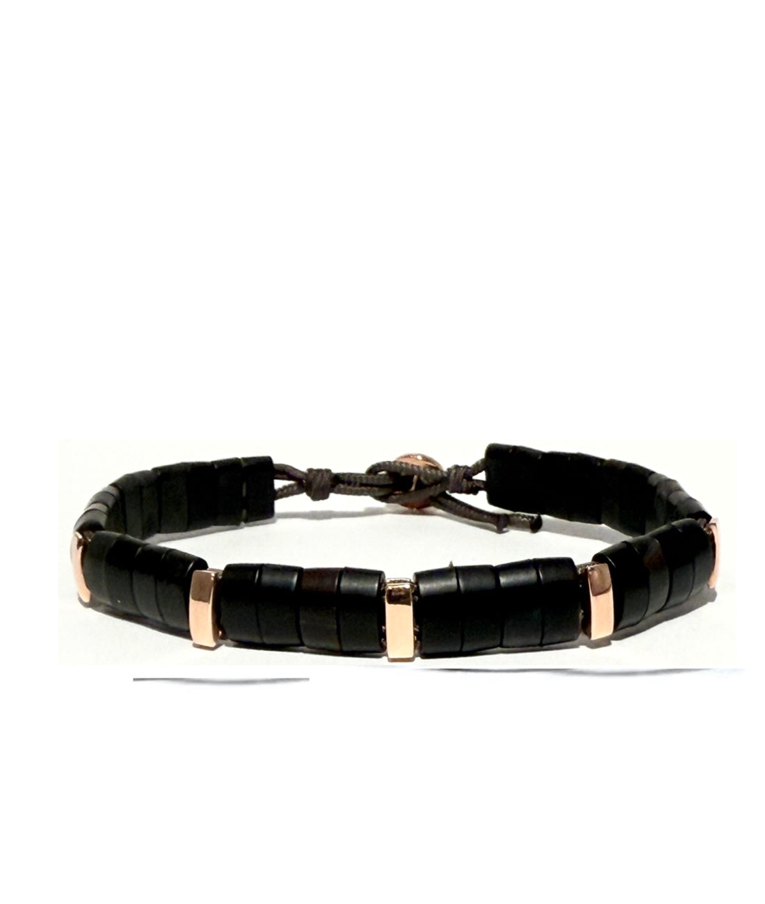 Water Buffalo Horn bracelet woven with parachute cord and accented with rose gold links and a gold button-and-loop closure. Fully sustainable and waterproof. i