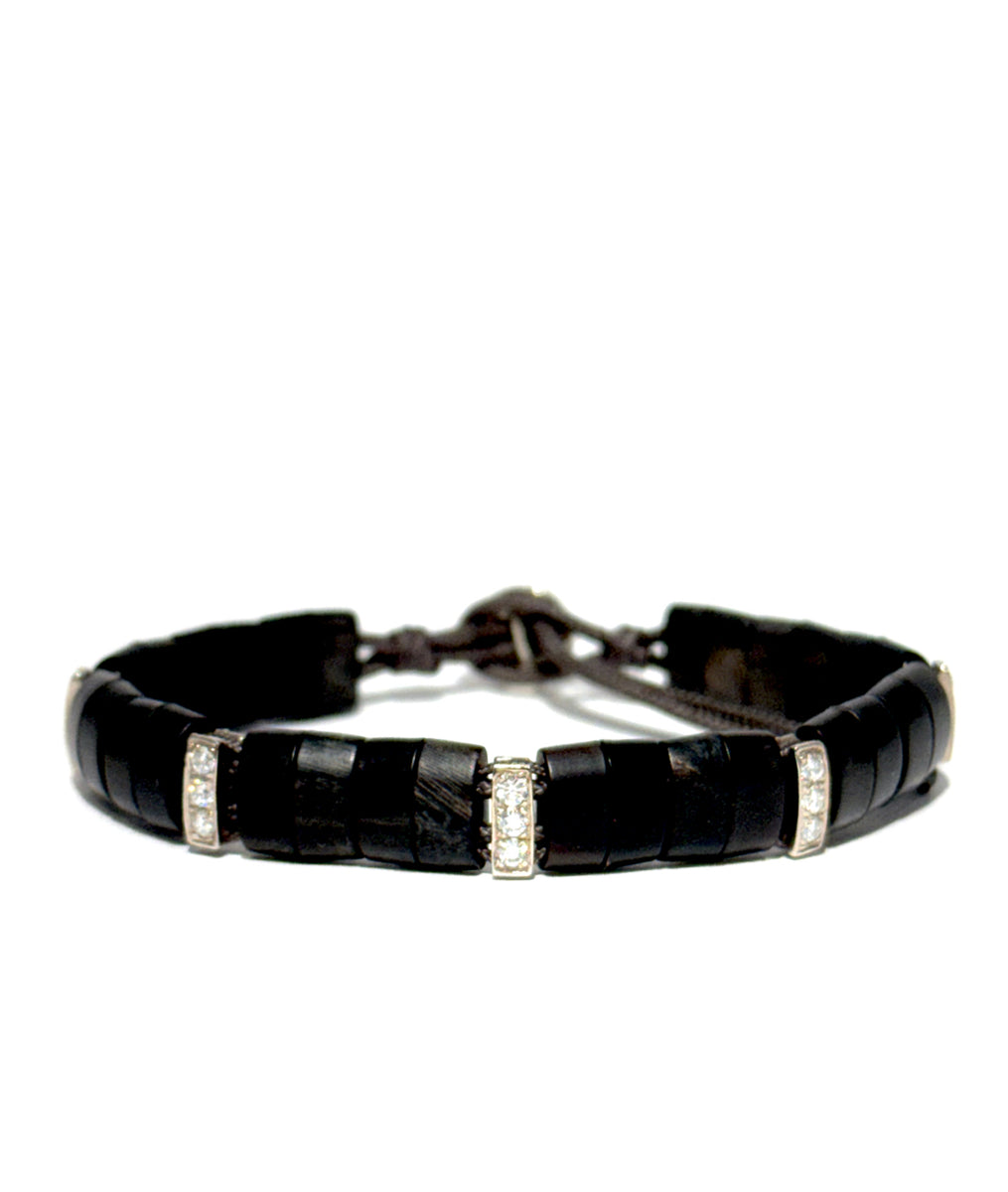 The Santos bracelet is crafted from hand-cut buffalo horn links, signature parachute cord, and accented with 14K gold pavé diamond links. Water-friendly and designed to age beautifully.