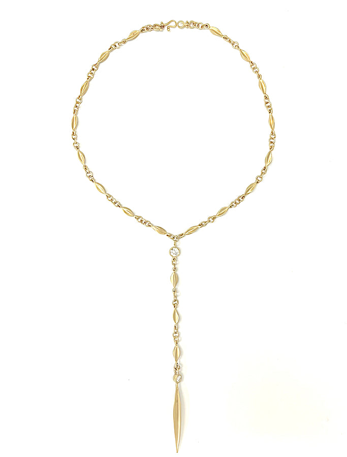 Seed like link chain necklace with large diamonds ending with a long pointy drop.