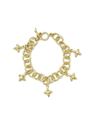 Bark textured link bracelet with flower shape charms and diamonds, handcrafted in 18kt gold. 