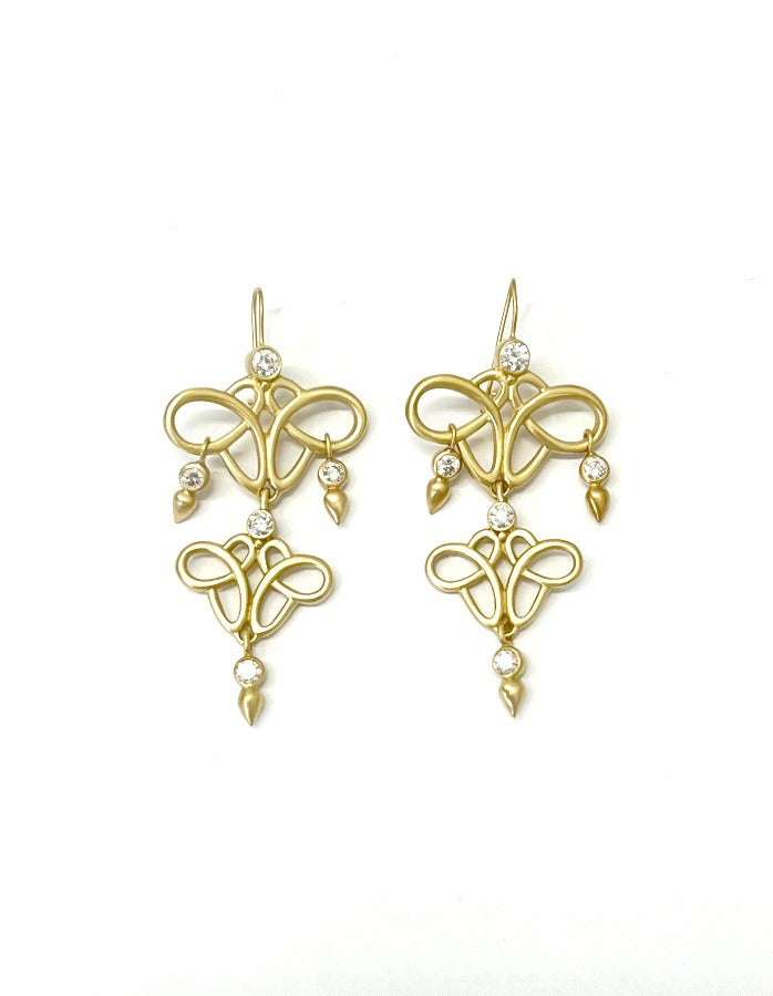 Curvy infinity shape drop earrings in 18kt gold with diamonds drops.