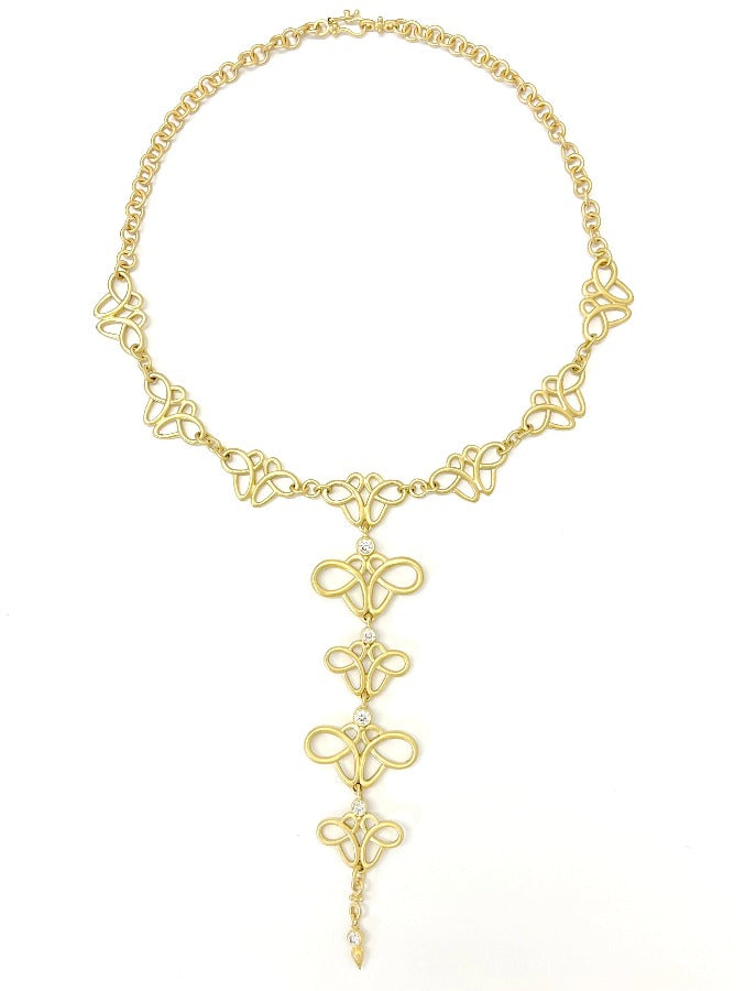 Curvy infinity shape design necklace in 18kt gold with diamonds drops.
