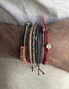Cherry Bracelet: Brown Parachute Cord Bracelet with Red Details and Sterling Silver  Enhance your style with the Cherry bracelet, featuring a red parachute cord with brown details and a unique cherry design in sterling silver.&nbsp;